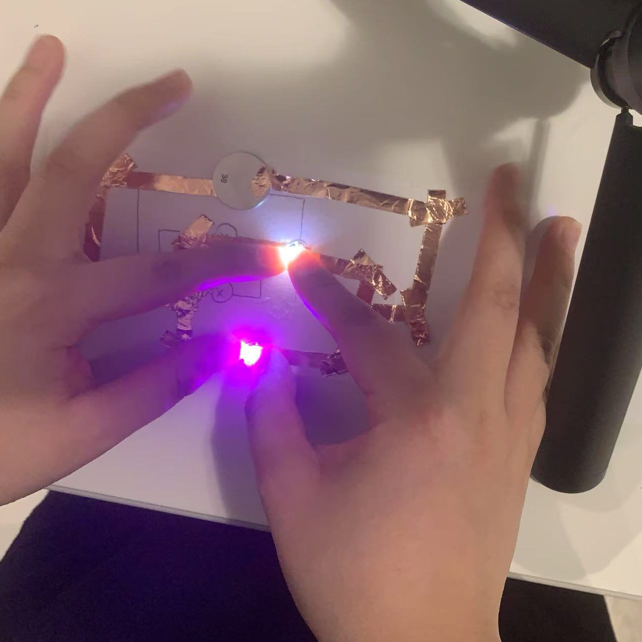 I pressed on the circuit, and both LEDs turned on, confirming that it works as intended.