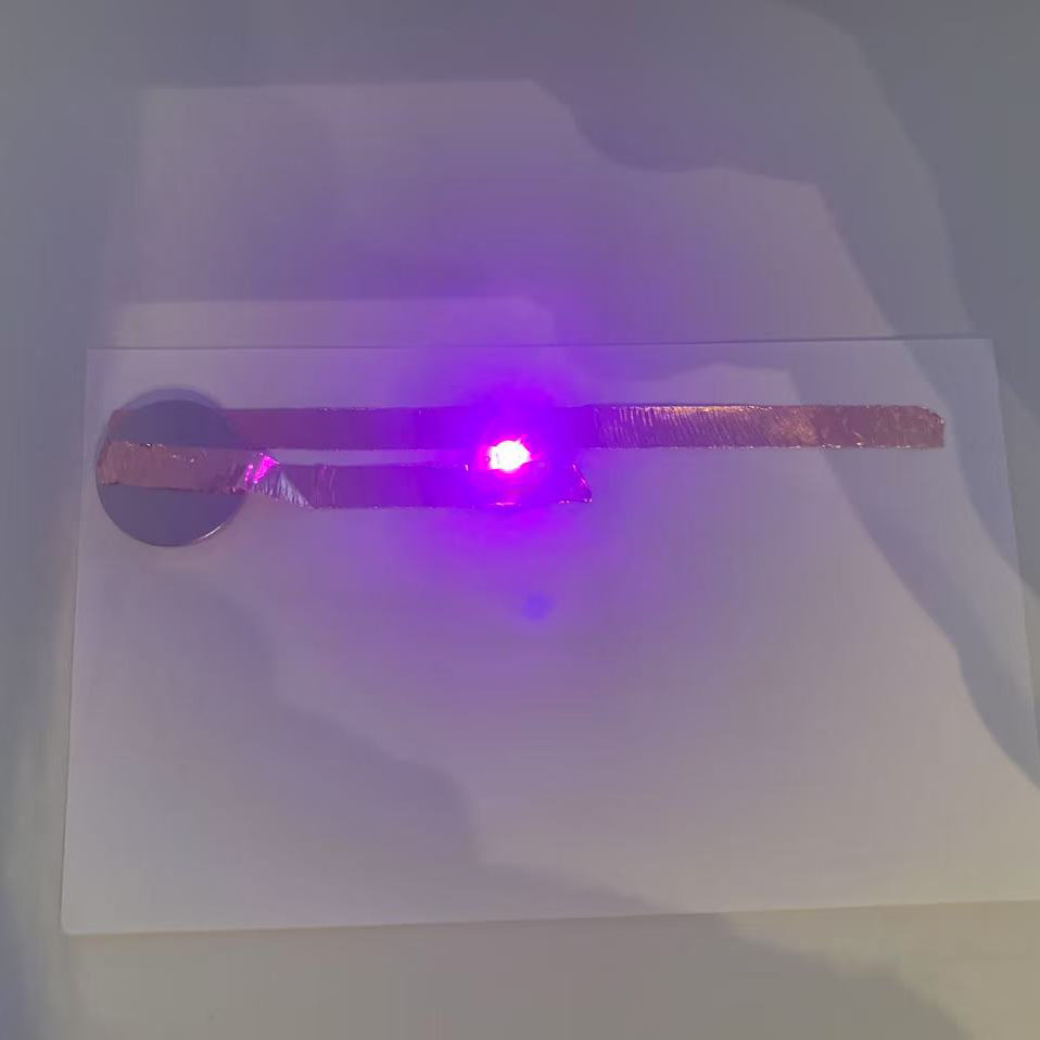 Using Tutorial 1 as a reference, I constructed the circuit with copper tape, a battery, and an LED. The illuminated purple light indicates that the circuit is working properly.