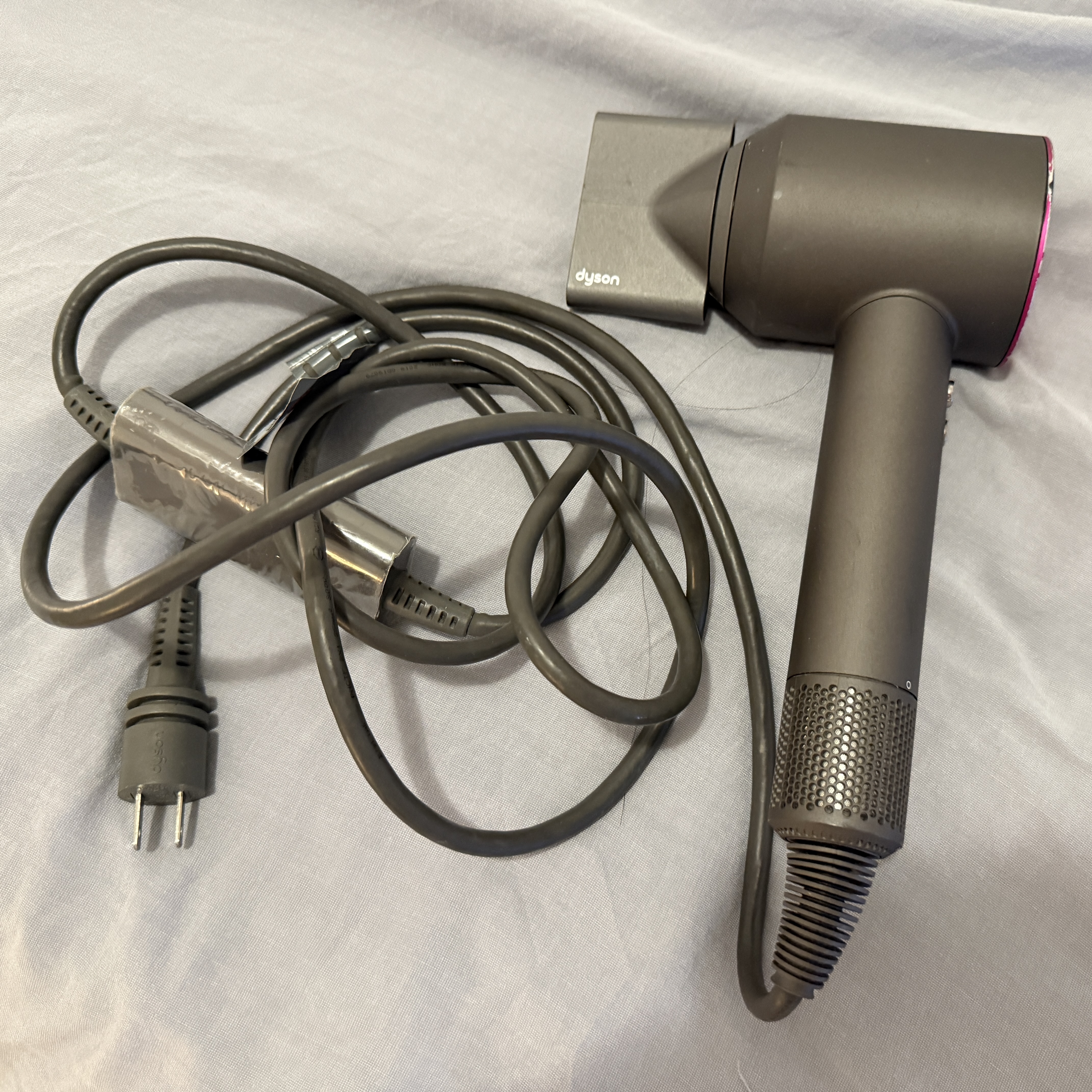  The loud whirring sound of a hairdryer blowing air.