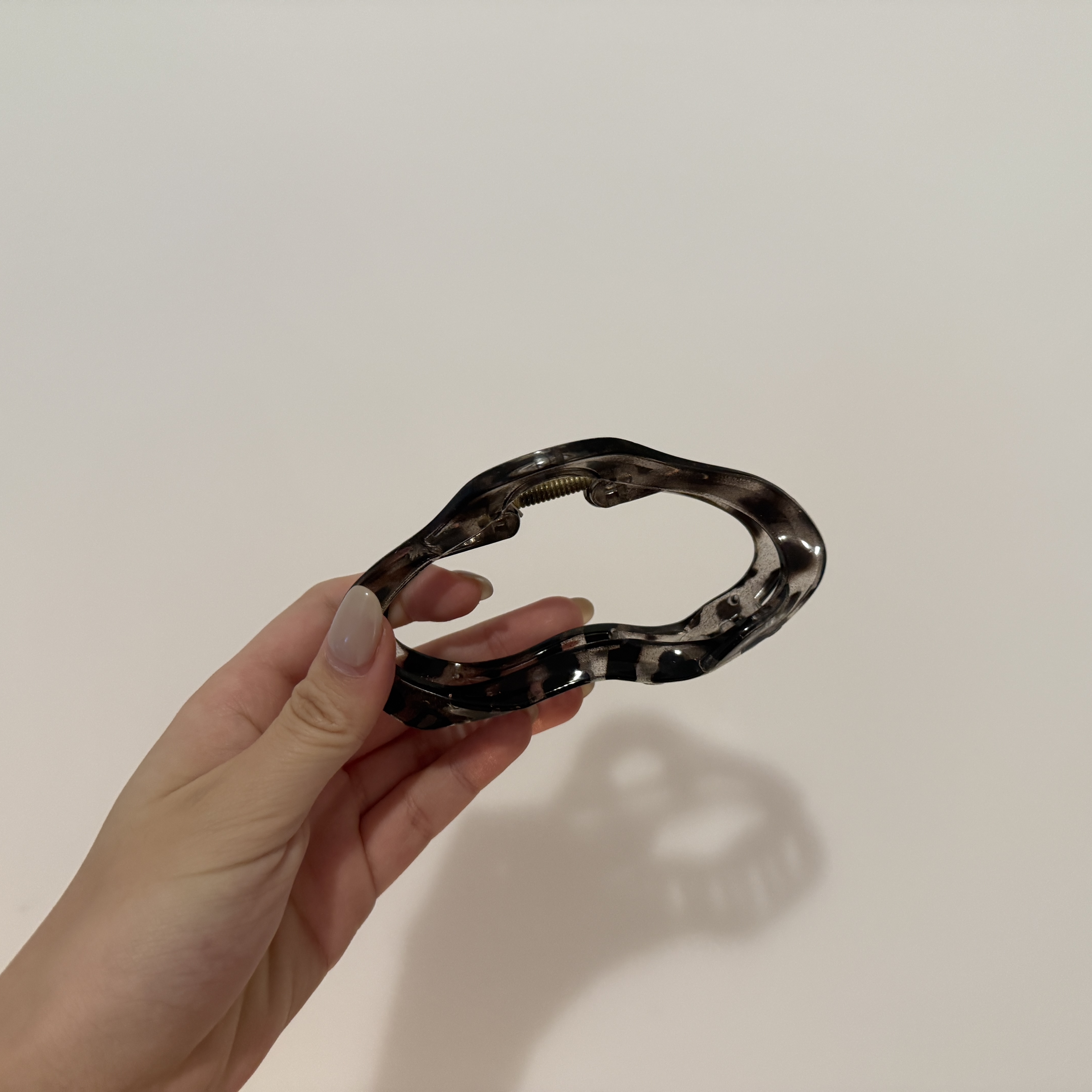 The snapping sound of a clip opening and closing.