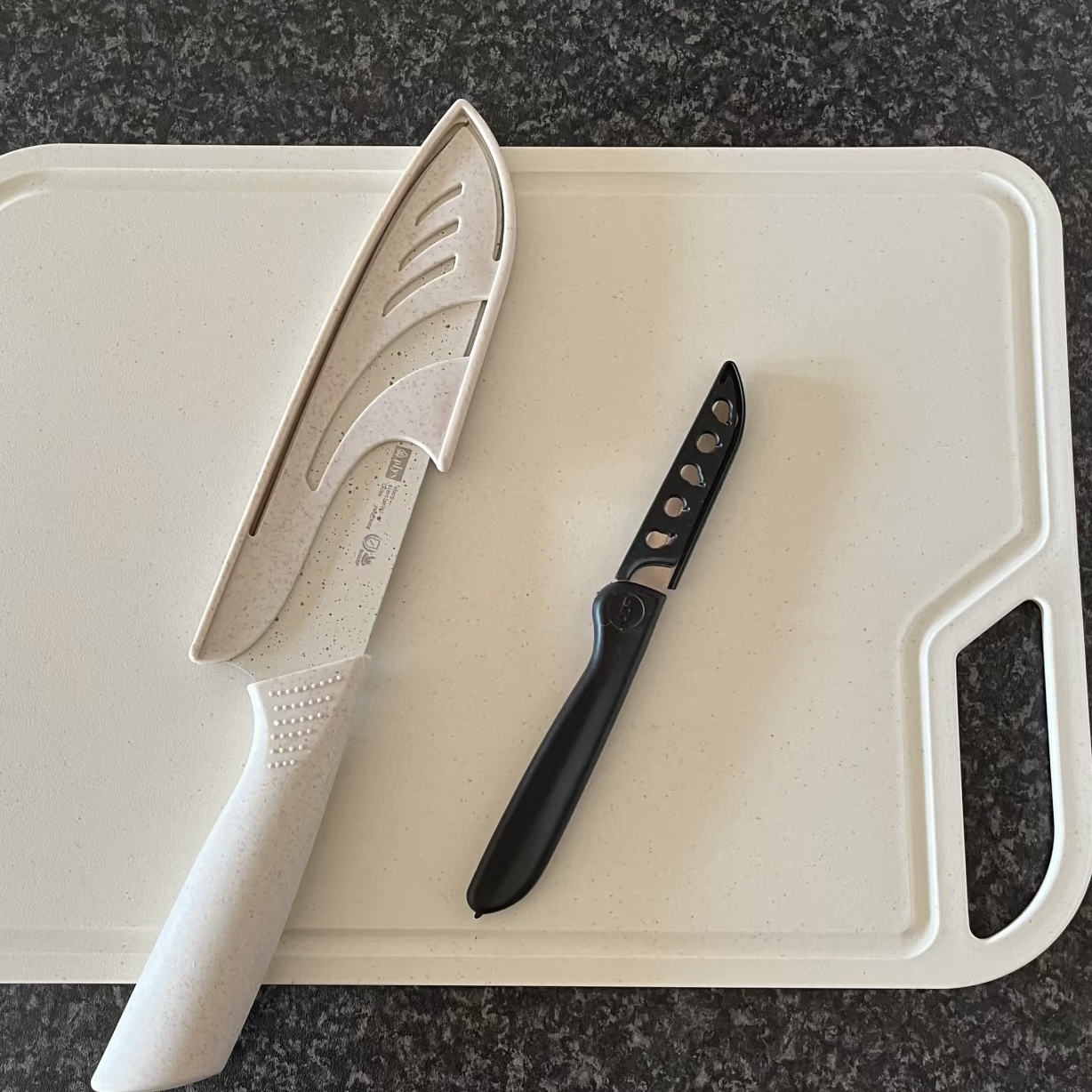 The rhythmic sound of a knife cutting food on a chopping board.