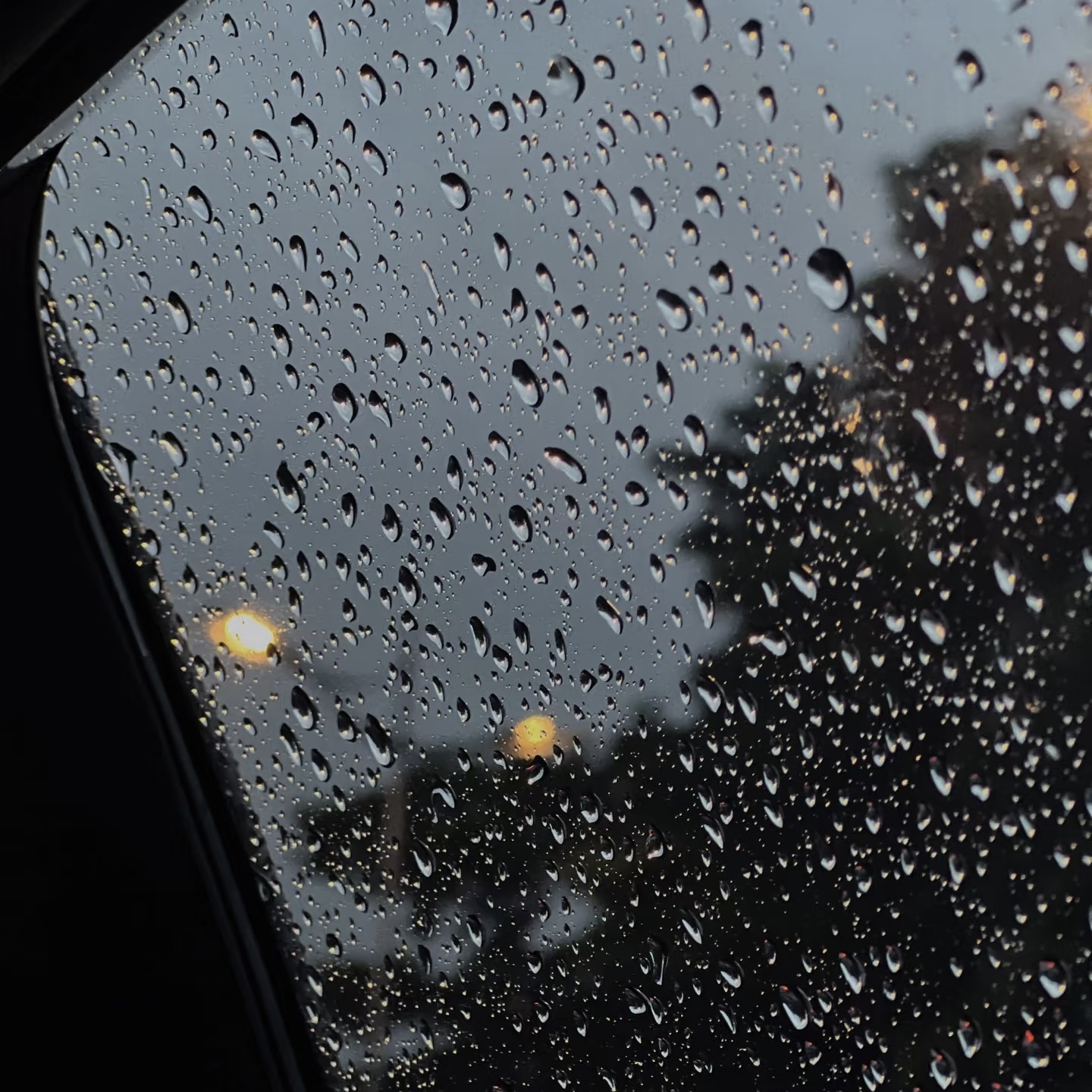 The pattering noise of raindrops hitting surfaces like windows or the ground.