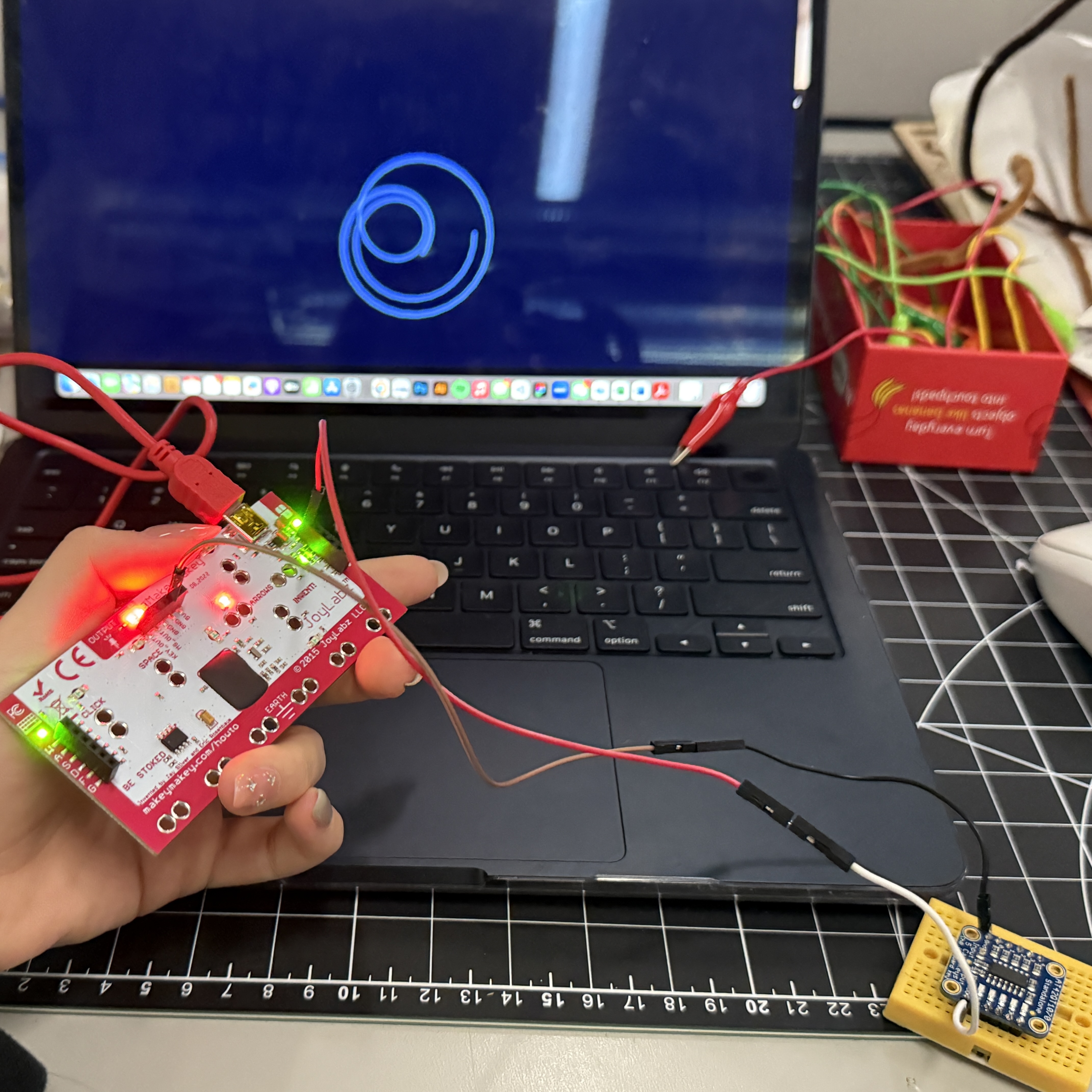 I tested my p5.js animation — each time I tapped Makey Makey, the shapes responded like I was painting with touches